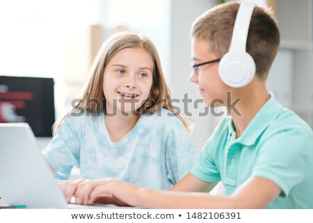 Friendly Classmates Of Middle School Discussing Data For Seminar Or Next Lesson Сток-фото © Pressmaster