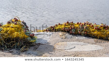 ストックフォト: Heap Of Yellow Fishnet On Ground At Sea