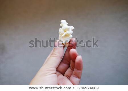 Stok fotoğraf: Hand Holding A Plastic Bag Of Popcorn