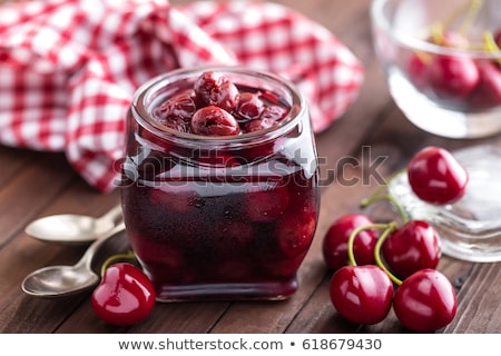 Zdjęcia stock: Berries Cherry With Syrup In A Glass Jar Canned Fruit