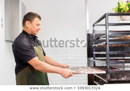 Foto d'archivio: Man With Smoking Tray At Fish Shop Or Smokehouse