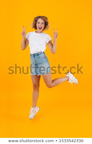 Stok fotoğraf: Full Length Image Of Cheerful Woman In Basic Clothing Jumping An