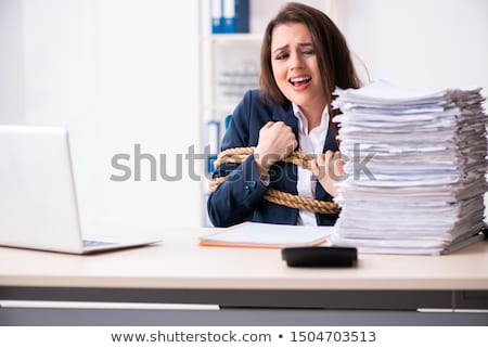 Stok fotoğraf: Young Beautiful Employee Tied Up With Rope In The Office
