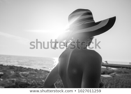 Сток-фото: Woman In A Straw Hat Watching The Sea