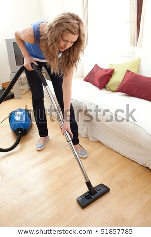 [[stock_photo]]: Exhausted Woman Hoovering The Living Room