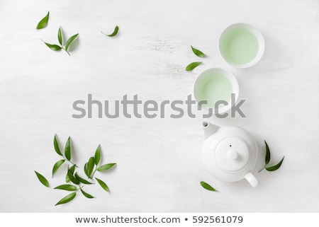 Foto stock: Black Teapot With Healthy Tea Leaves