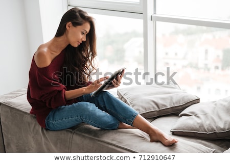 Stock photo: Young Woman Sitting On Windowsill