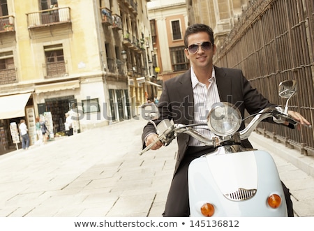 Stok fotoğraf: Happy Young Businessman Riding On A Motorbike