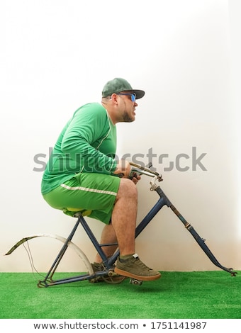 Foto d'archivio: Lunatic Cyclist With Bike On The Background