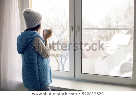 Stock photo: Girl Sitting On Sill At Home Window In Winter