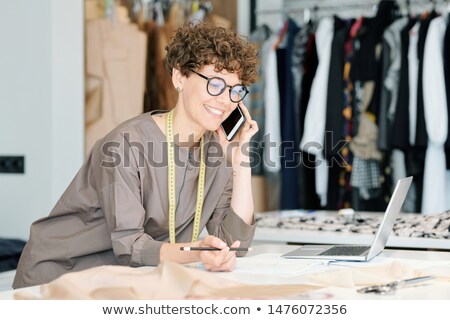 Female Tailor In Eyeglasses And Casualwear Talking To Clients On The Phone Сток-фото © Pressmaster