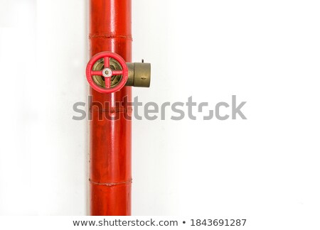 Stock photo: Plumber Securing Pipe To Wall