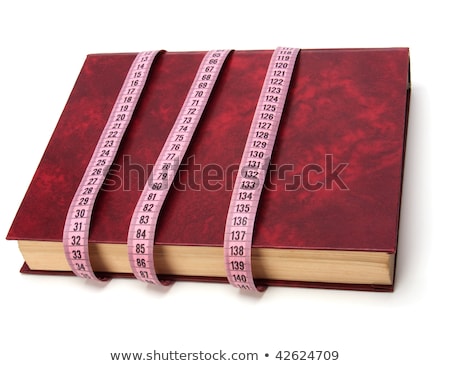 [[stock_photo]]: Tape Measure Wrapped Around Book Isolated On White Background