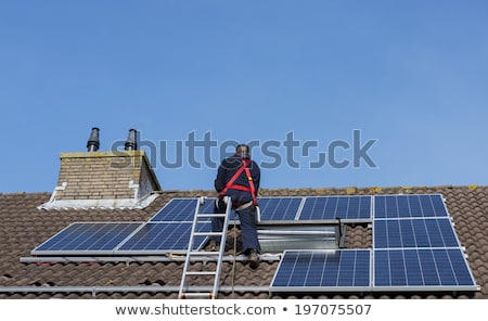 Stock fotó: Man Climbing The Ladder With Solar Panel