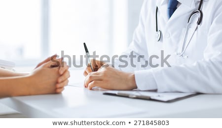 Stock photo: Doctor Taking Notes From Patient