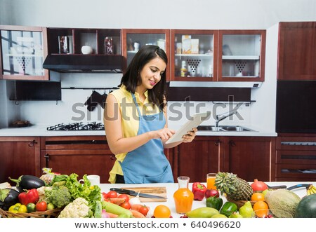 Foto d'archivio: Happy Women With Tablet Pc In Kitchen