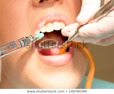 Foto stock: Female Dentist Provides Dental Anesthesia To Patient