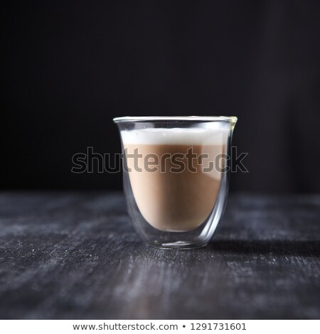 A Glass Cup Of Hot Flavored Cappuccino Presented On A Black Wooden Table With Copy Space Сток-фото © artjazz