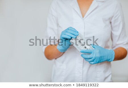 Stock fotó: Pills With Medicine Box And Syringe Againsy A White Background