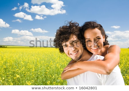 [[stock_photo]]: Relationship Romance Amorous Couple With Flowers Embracing