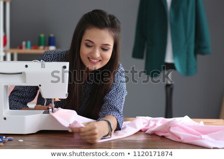 Foto stock: Female Tailor Using Sewing Machine