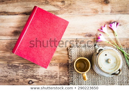 Stok fotoğraf: Tea Cups With Teapot With Red Book On Old Wooden Table Top View