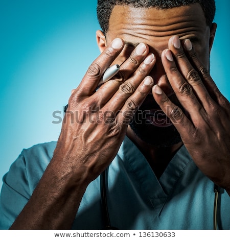 [[stock_photo]]: Doctor With Head In His Hands