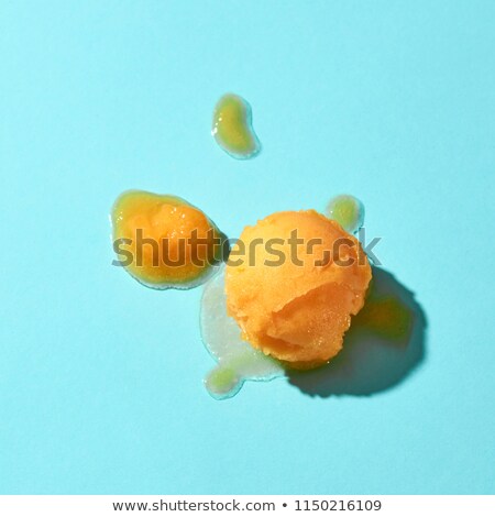 Flat Lay Of A Yellow Ice Cream Scoop And Melted Ice Cream On A Blue Background With Hard Shadows Stockfoto © artjazz