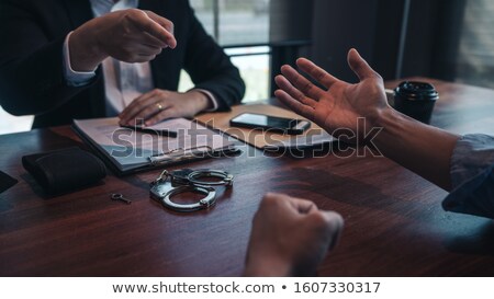 Stock fotó: Police Officer Presenting Evidence To Suspect After Committed A