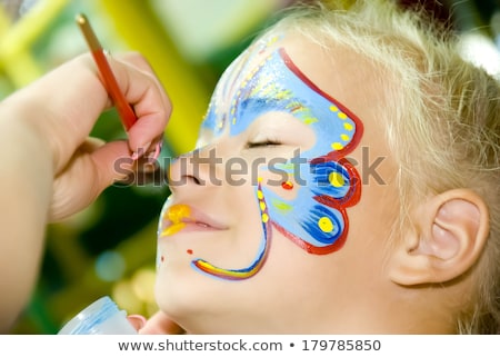 Stockfoto: Little Girl With Face Paint Looking Up