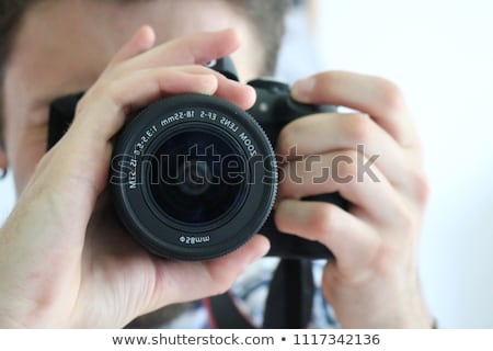 Foto d'archivio: Photographer Taking Pictures Of The Young Woman Isolated