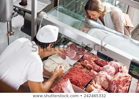 Foto stock: Girl In Butchers Shop