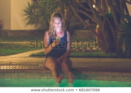 [[stock_photo]]: Peaceful Blonde Sitting On Pools Edge