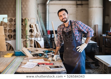 Сток-фото: Carpenter Working Carefully Looking At The Plans Work In Carpent