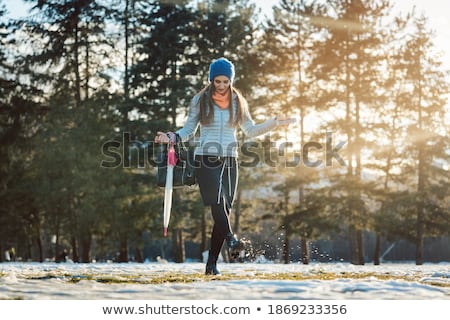 Stock fotó: Woman Walking Thru Slushy Snow