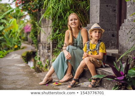 Foto d'archivio: Mom And Son Travelers Are Walking Along The Street Ubud Traveling With Children Concept