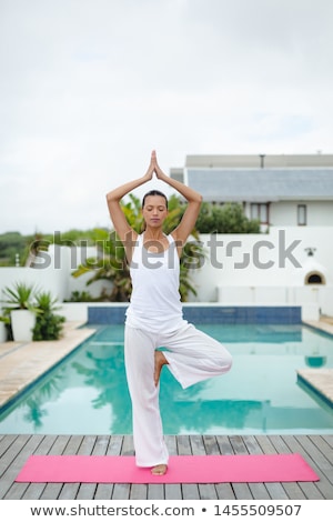 Stock foto: Front View Of Beautiful Fit Young Mixed Race Woman Performing Yoga In The Backyard Of Home