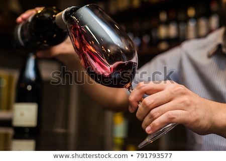 Foto stock: Man Pouring A Glass Of Red Wine