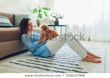 Foto stock: Woman Sitting At The Table And Holding Orange