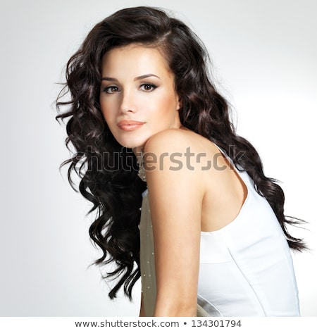 Foto stock: Side View Of Black Haired Woman Posing In Studio