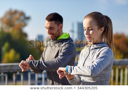 Stock photo: Couple With Fitness Trackers Running Outdoors