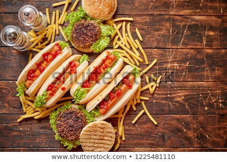 Foto stock: Fastfood Assortment Hamburgers And Hot Dogs Placed On Rusty Wood Table