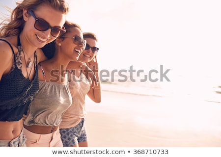 Сток-фото: Group Of Smiling Women In Sunglasses On Beach