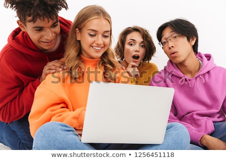 Foto stock: Group Of Friends Students Isolated Over White Wall Background Using Laptop Computer