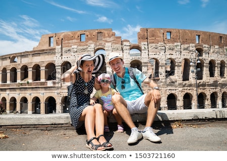 Stockfoto: Young Mother And Daughter Sitting In Front Of Colosseum