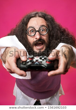 Stok fotoğraf: Portrait Of A Bizarre Nerd Holding A Gamepad