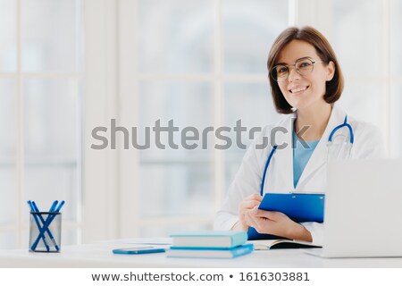 Foto stock: Female Doctor Writes Prescription On Special Form Works In Private Clinic Wears White Medical Gown