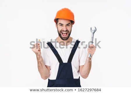 Сток-фото: Happy Young Man Holding Credit Card And Wrench
