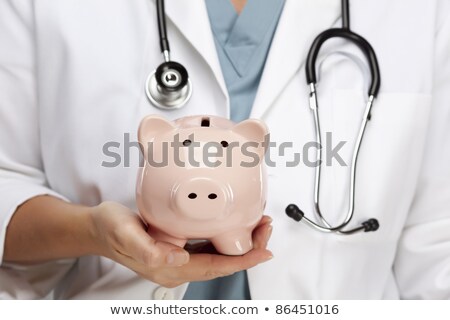 Stock fotó: Doctor With Stethoscope Holding Piggy Bank Abstract