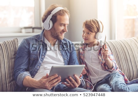 Zdjęcia stock: Cute Handsome Boy Listening To Music By Headphones